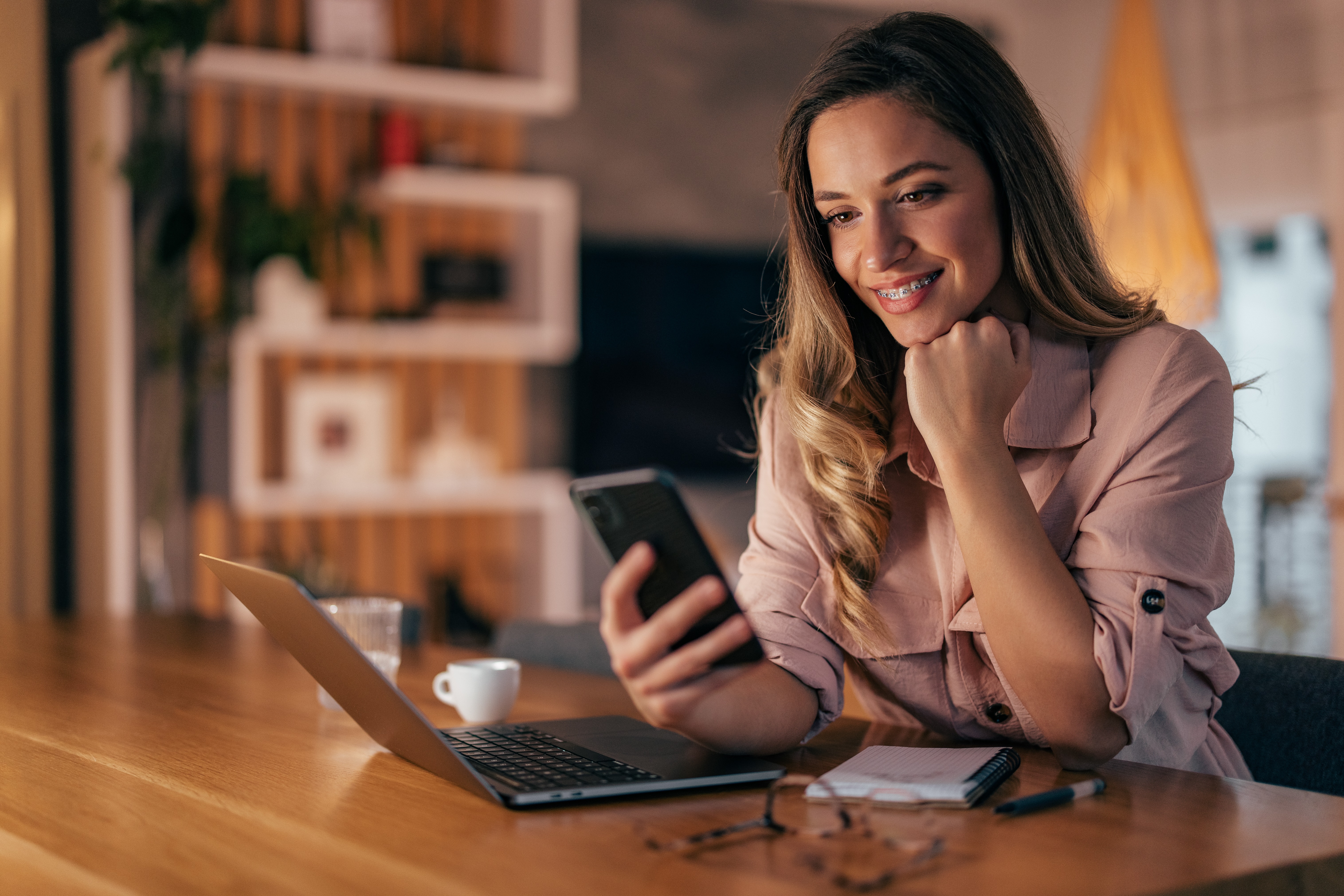 happy-woman-looking-at-smart-phone-at-home-receiv-2022-12-15-07-50-22-utc.jpg